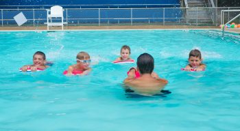 Airy counselor teaching swim