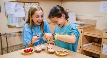 Campers decorating cupcakes