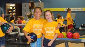 Girls holding a bowling ball