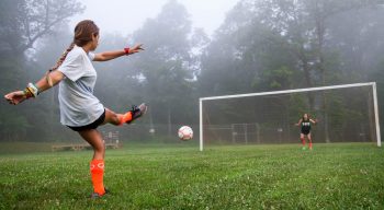 Girl kicking a soccer ball