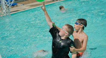 Airy campers playing basketball in pool